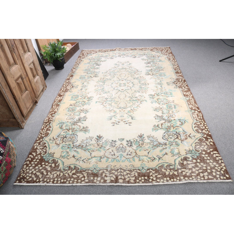 Vintage Turkish-inspired large beige floral rug designed for enhancing living room aesthetics