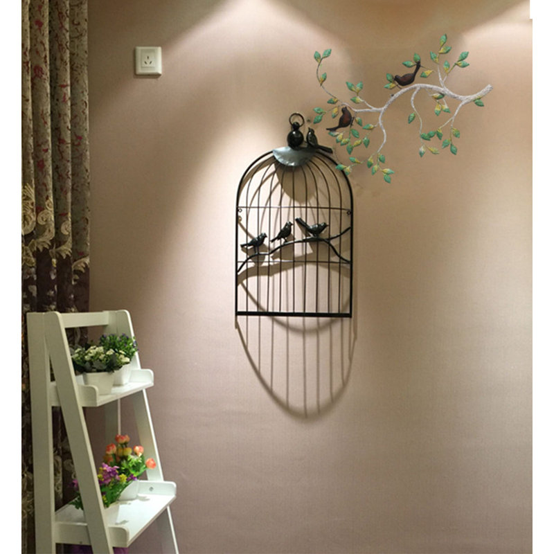 Décoration murale vintage en métal représentant un oiseau en forme de branche et de cage à oiseaux, idéale pour le salon ou la maison.