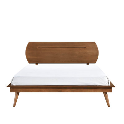 Chambre avec grand lit plateforme et tête de lit ovale en bois brun