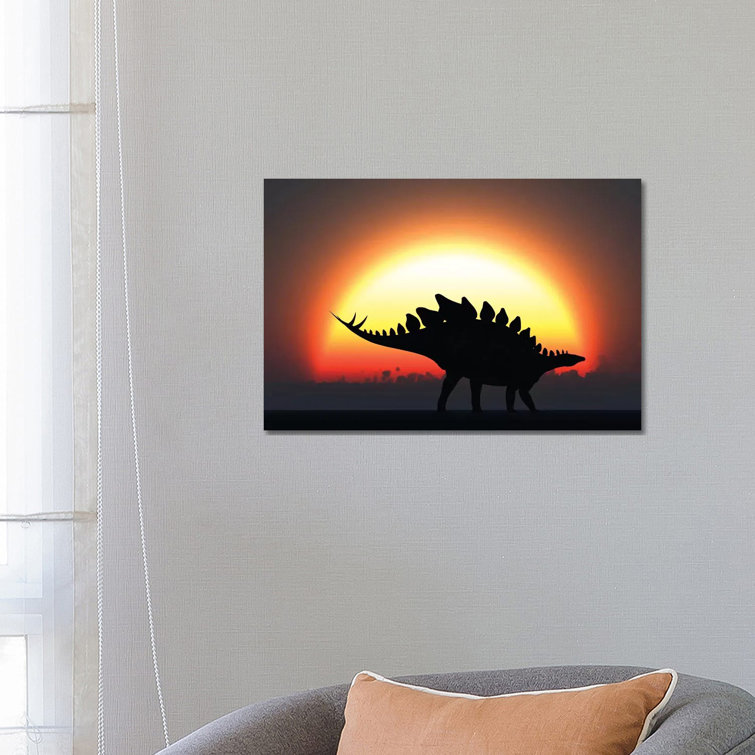 A Stegosaurus Silhouetted against the Setting Sun at the End of a Prehistoric Day by Mark Stevenson - Wrapped Canvas Graphic Art