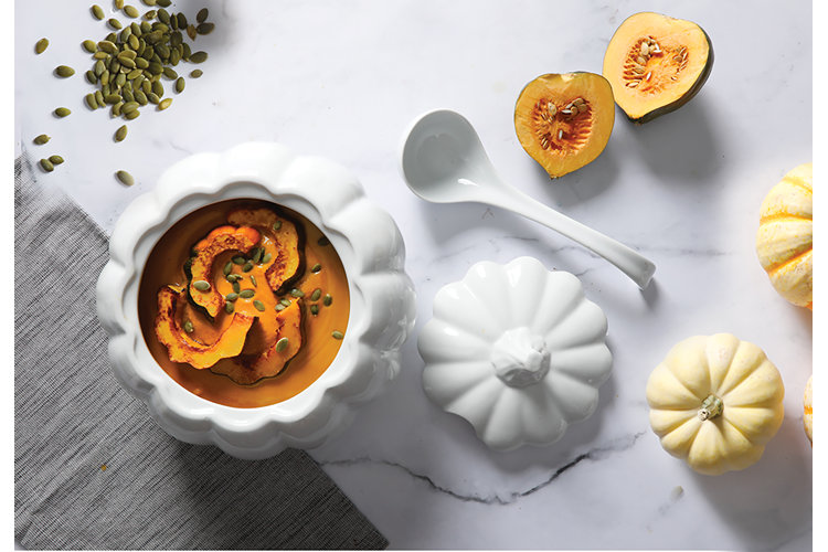 pumpkin shaped tureen holding acorn squash soup