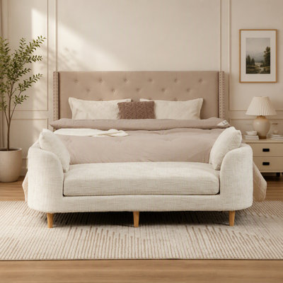 Banc de lit moderne capitonné avec accoudoirs et coussins cylindriques