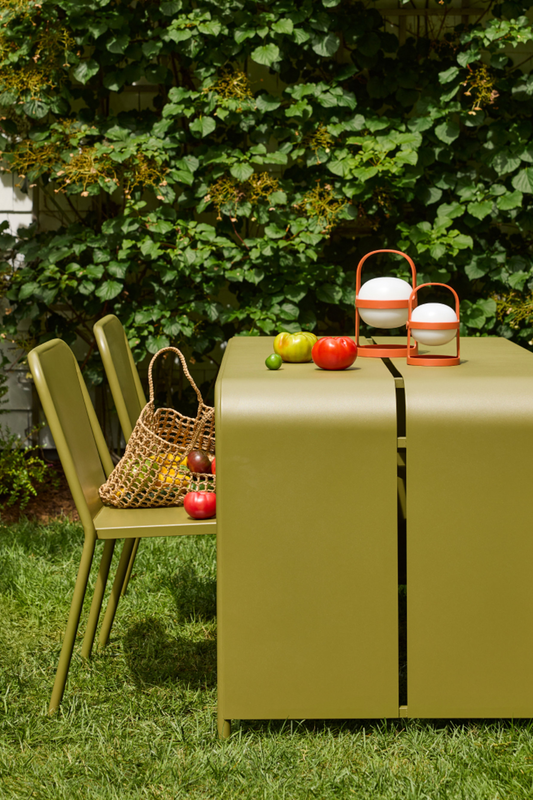 Outdoor dining set with lamps and produce.