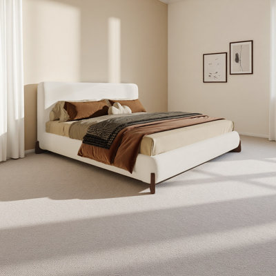 Élégant lit tapissier avec pieds en bois massif brun foncé, centre de chambre luxueux et confortable, très grand