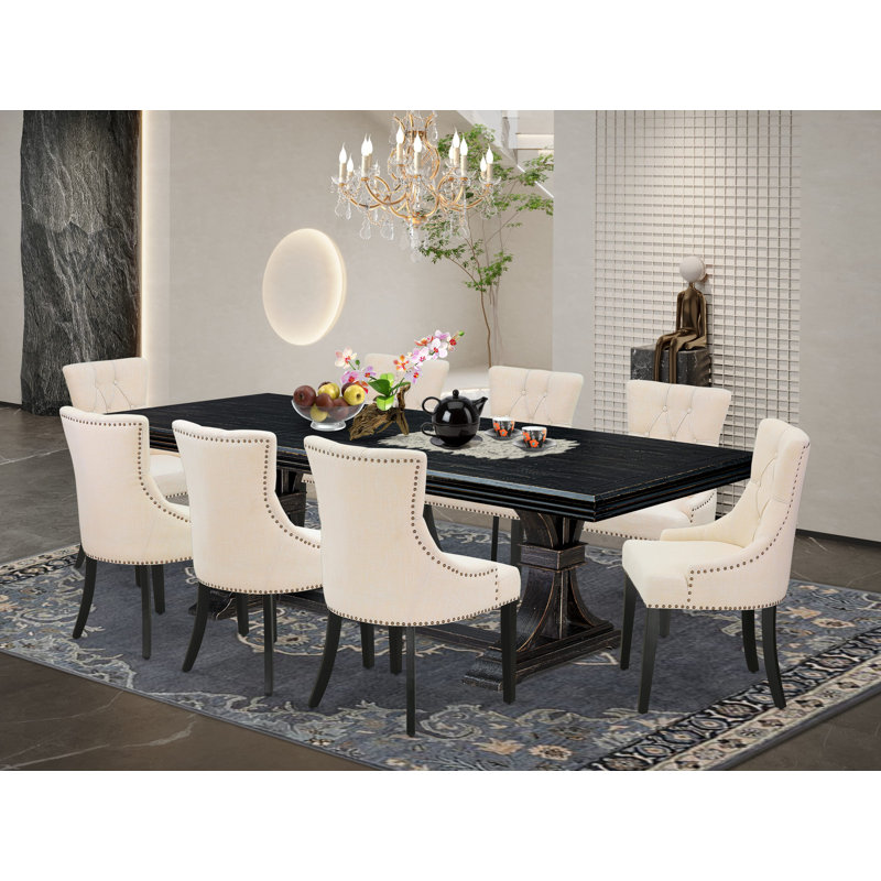 L'ensemble de salle à manger 9 pièces comprend une table en bois et 8 chaises de salle à manger en tissu de lin beige clair et des pieds noirs avec un dossier capitonné - finition noir sablé.