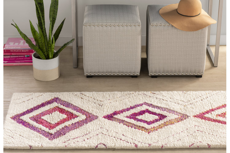 BOho style area rug with pink diamonds and cream colored background