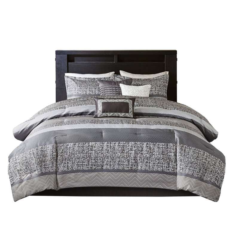 Édredon grand / gris taupe 7 pièces. Tissu. Comprend un édredon, des taies décoratives, des coussins décoratifs et une jupe de lit. Lavable à la machine pour grand lit. Gris / taupe Avec des détails brodés et plissés. Contient 2 3 1