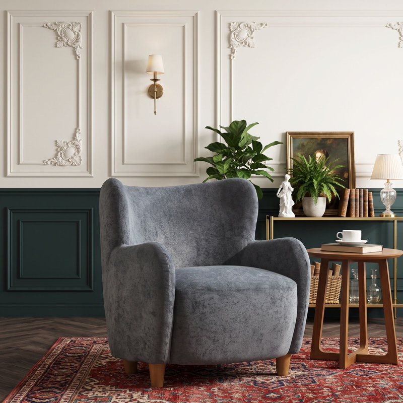 Fauteuil à oreilles en velours avec coussin à ressorts ensachés et pieds en bois massif