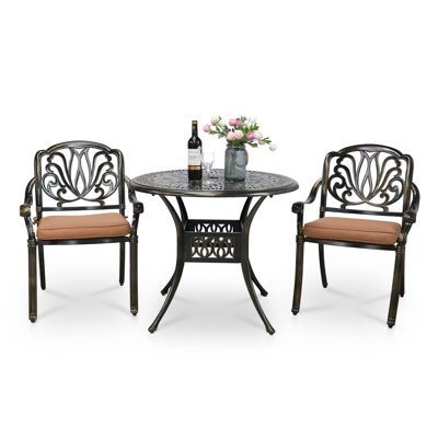 Deshira 2 - Person Patio Dining Set with Round Table , Cushions Included