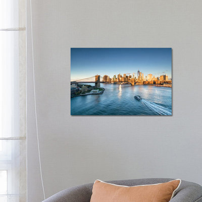 Manhattan Skyline And Brooklyn Bridge At Sunrise by Jan Becke - Wrapped Canvas Print