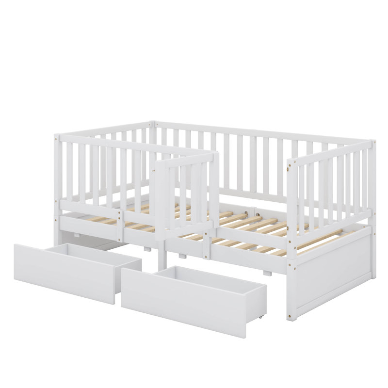 Lit de jour simple en bois avec garde-corps en forme de clôture pour la sécurité et deux tiroirs intégrés pratiques pour le rangement