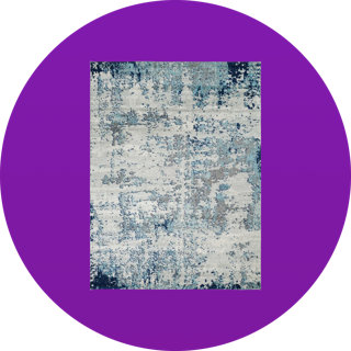 Rectangular area rug with an abstract distressed pattern in shades of blue, grey, and cream on a solid purple circular background.