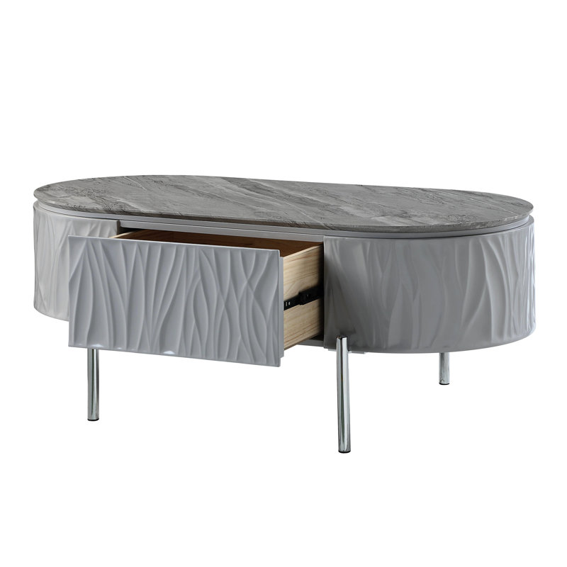 Table basse grise ultrabrillante avec un design ovale et un support robuste pour le salon