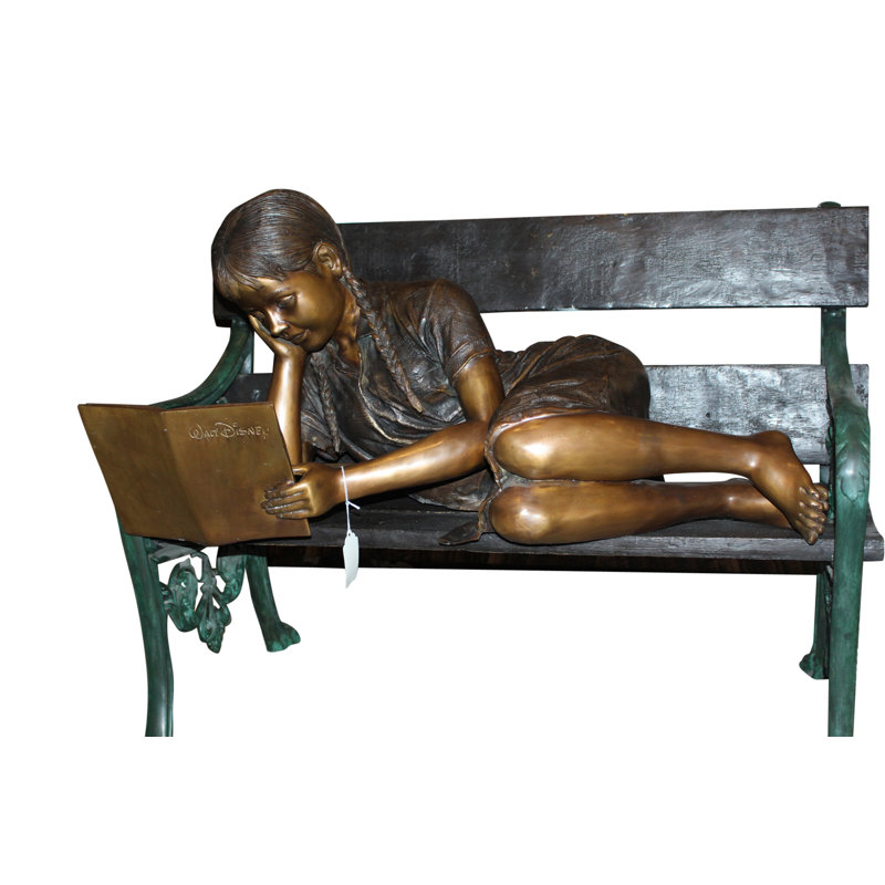 Girl laying on a bench reading a book Bronze Statue -  Size: 27"L x 39"W x 32"H