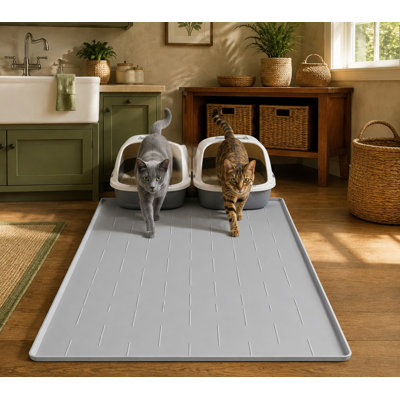 Deep grooves on this extra-large 40 x 28 in silicone litter box mat capture litter, while a raised edge catches urine and spills; the mat is soft on kitty paws, easy to clean, and equipped with non-slip backing.