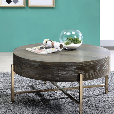 Table basse ronde en brun et champagne, un tiroir pour le rangement, base en métal en forme de x, chêne, 16 po de hauteur avec des teintes champagne, construction, haute