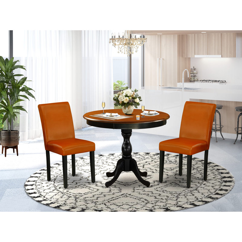 L'ensemble de 3 tables de salle à manger modernes comprend une table de cuisine ronde avec piédestal et 2 chaises de salle à manger en similicuir noir et cerise