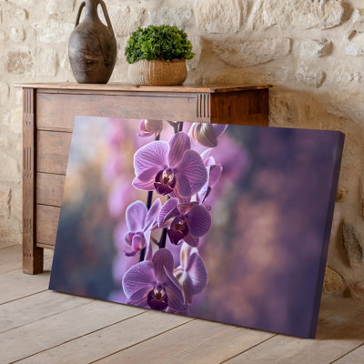Canvas A Close Up View Of Delicate Purple Orchids Cascading Gracefully Wall Art On A Slender Stem Showcasing Their Soft Velvety Petals Canvas Wall Art