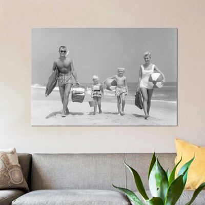 " 1950s Family Of Four Walking Towards Camera With Beach Balls Umbrella Picnic Basket And Sand Bucket " by Vintage Images