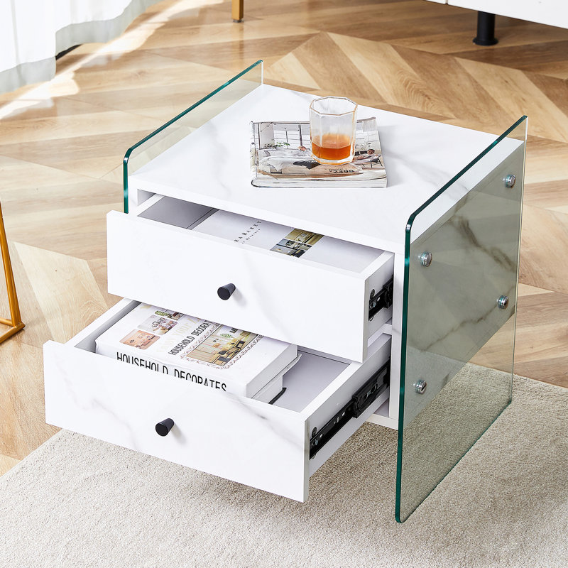 Double-drawer bedside table. The board surface is MDF with white grain sticker, and both sides are transparent tempered glass. The design is simple and elegant, with excellent storage functions.