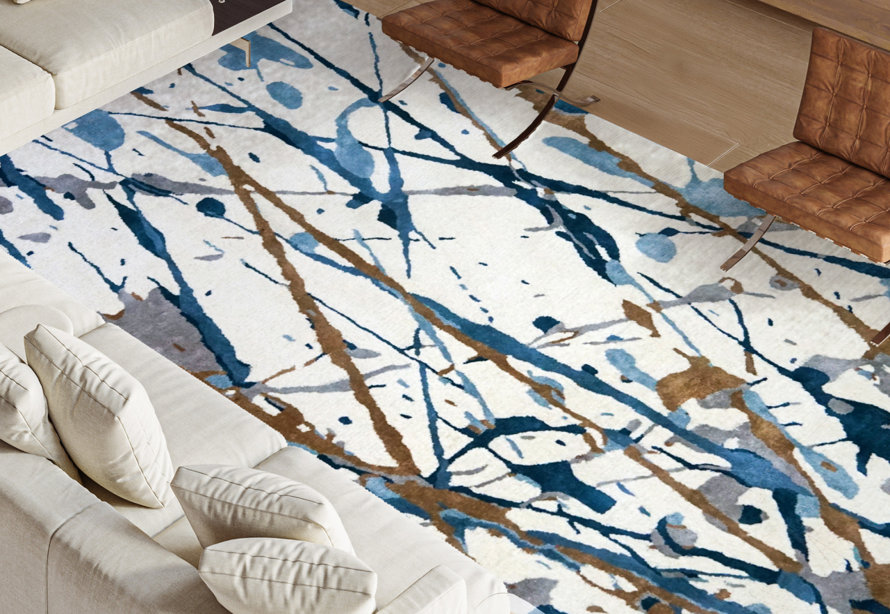 Overhead shot of a living room rug with a splashy abstract design.