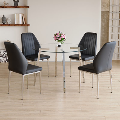 Ensemble de salle à manger moderne: table circulaire en verre trempé avec pieds en métal argenté et 4 chaises en cuir PU noir, avec dossiers allongés