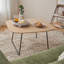 Table basse ronde avec plateau en bois et base en acier, design compact et moderne pour le salon ou la chambre à coucher