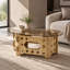Table basse ovale de 98 x 58 cm avec dessus en verre caramel et piètement en bois sculpté