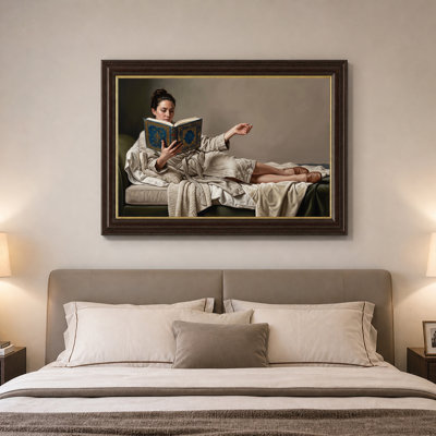 Woman Reading Ornate Blue Book on Green Sofa Canvas Wall Art