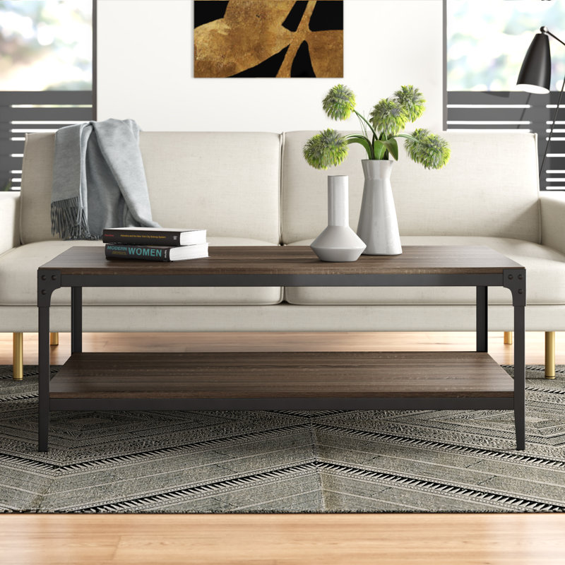 Sleek wooden coffee table with vases and books in a stylish, minimalist living room with neutral colors and modern decor.