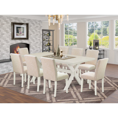 Ensemble de salle à manger 9 pièces comprenant une table rectangulaire à pattes en X et 8 chaises rembourrées en lin beige clair.