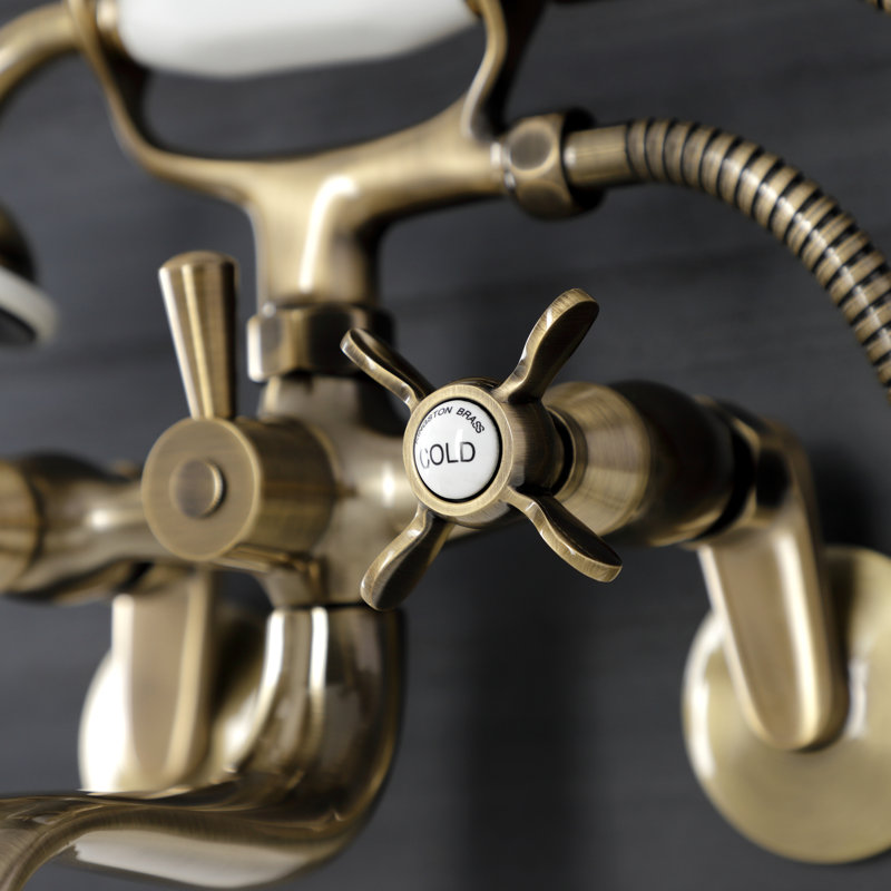 Kingston Brass Essex Three-Handle 2-Hole Wall Mount Clawfoot Tub Faucet with Handshower, Antique Brass