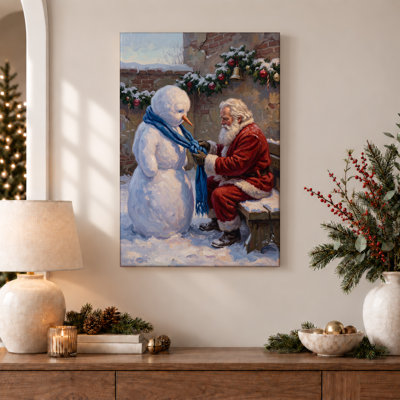 Red Suit Santa Tying Blue Scarf on Snowman Christmas Canvas Wall Art