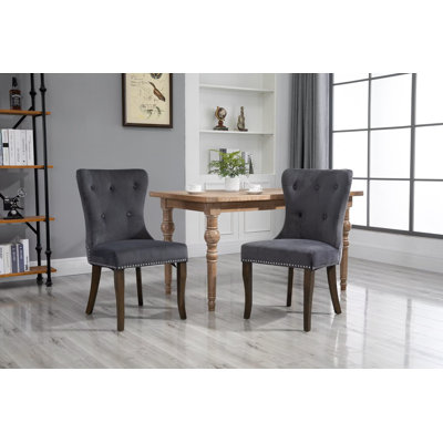 Chaise de salle à manger rembourrée en gris à oreilles capitonnée Dupras