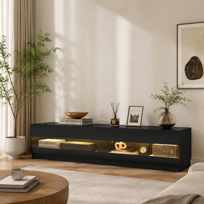 Meuble télé noir ultrabrillant avec éclairage intégré, pouvant accueillir des téléviseurs de 75 po ou moins, comprenant plusieurs compartiments de rangement et un meuble de rangement multifonctionnel pour le divertissement audiovisuel.