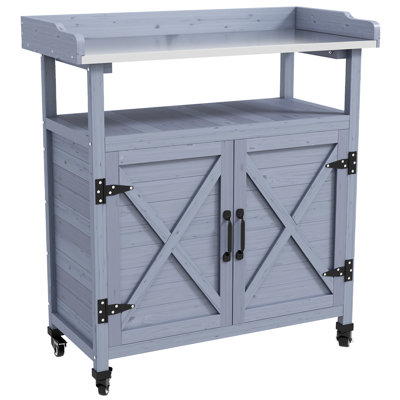Gray Potting Table With Storage. Wooden Construction. Aluminum Top. Rubber Wheels For Mobility. Rust. For Patio Gardening. 34.4"W X 16"D 37.5"H Bench. Storage Compartment. Work Surface. Smooth