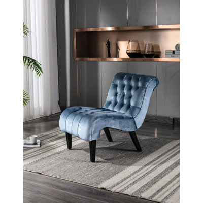 Fauteuil sans accoudoirs en velours bleu, rembourrage confortable pour un moment de détente