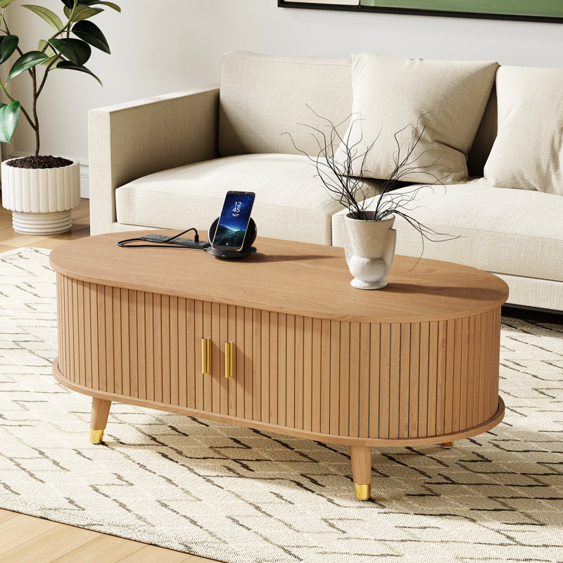 Table basse ovale cannelée avec station de charge, espace de rangement, porte de tambour coulissante et pieds en bois