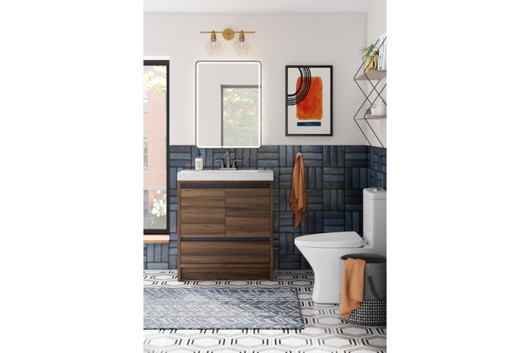 modern bathroom with a half wall of blue rectangular tiles and hexagonal floor tiles