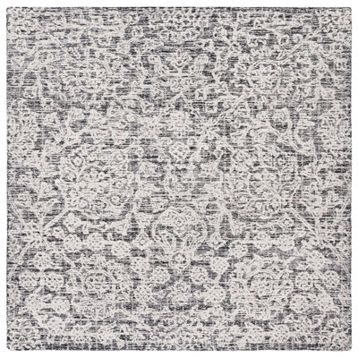 Caniah Hand Tufted Wool/Viscose/Cotton Floral Rug in Black/Ivory