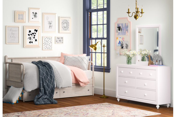light gray wood trundle with light gray and pink bedding