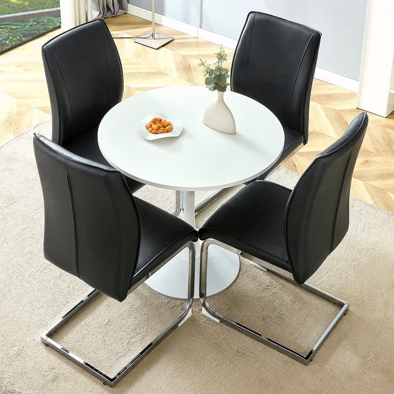 Ensemble de table et de chaises. Petite table ronde stable en forme de verre - 31,9 po x 31,9 po avec une chaise en polyuréthane doux et confortable avec un pied en métal argenté arqué. Créez votre espace exclusif de luxe discret.