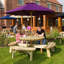 Gloria 8 - Person Wood Patio Dining Set with Round Table