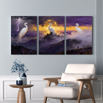 Ensemble de 3 tableaux sur toile tendue représentant un héron blanc dans un ciel orageux