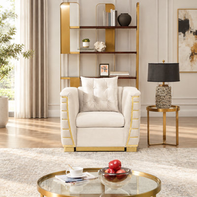 Sofa une place en velours avec des détails métalliques dorés et un coussin décoratif