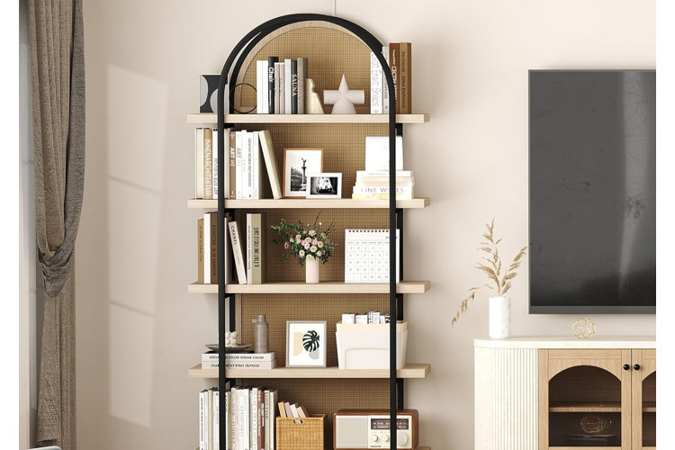 modern arched etagere with black metal frame and light wood shelves styled with books, flowers, and decorative accents