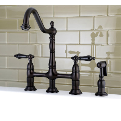 Kingston Brass Duchess Two-Handle 4-Hole Deck Mount Bridge Kitchen Faucet with Brass Side Sprayer
