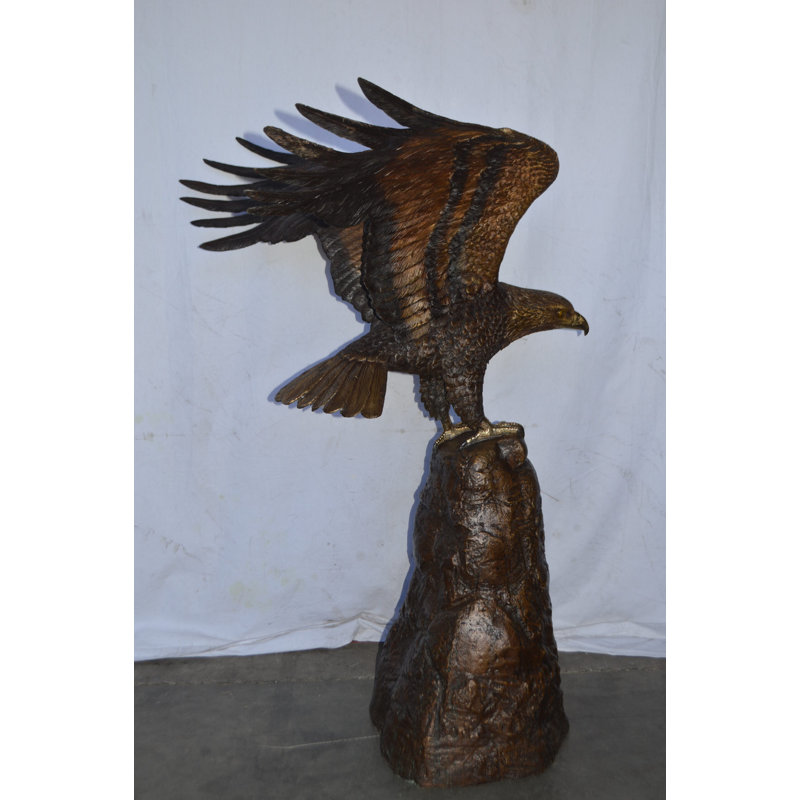 Eagle Landing On A Rock Bronze Statue - Size: 51"L X 36"W X 58"H.