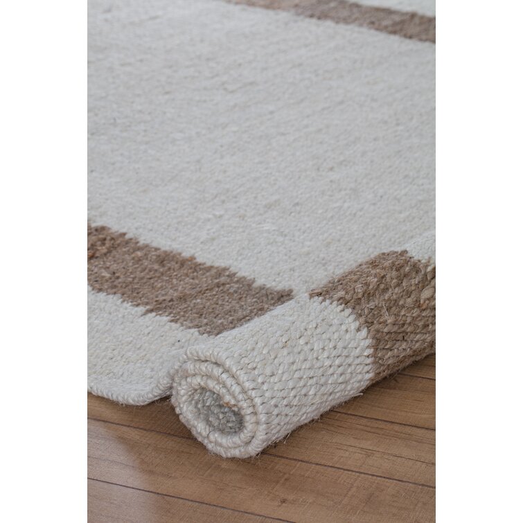 https://assets.wfcdn.com/im/58617679/resize-h755-w755%5Ecompr-r85/9569/95699505/Kenwood+Hand+Loomed+Jute%2FSisal+Ivory%2FBrown+Rug.jpg