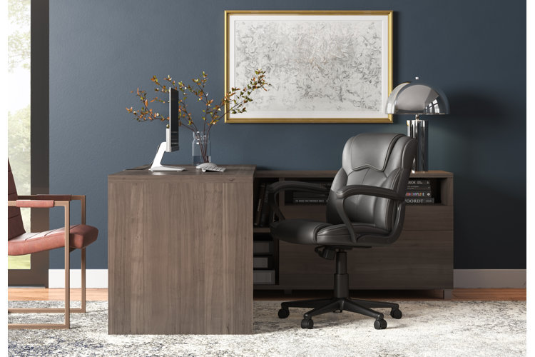 modern home office with navy blue walls and an ergonomic desk setup